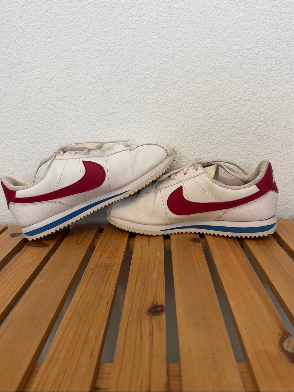 Nike Men's White Leather Sneakers with Red Swoosh and Blue Stripe